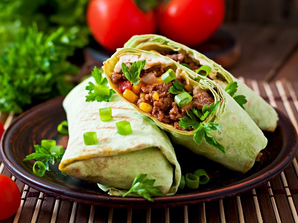 burritos wraps with minced beef vegetables wooden surface