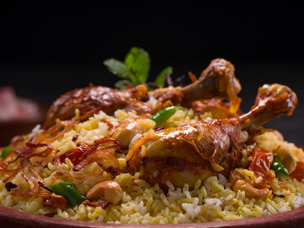 chicken dhum biriyani using jeera rice spices arranged earthen ware