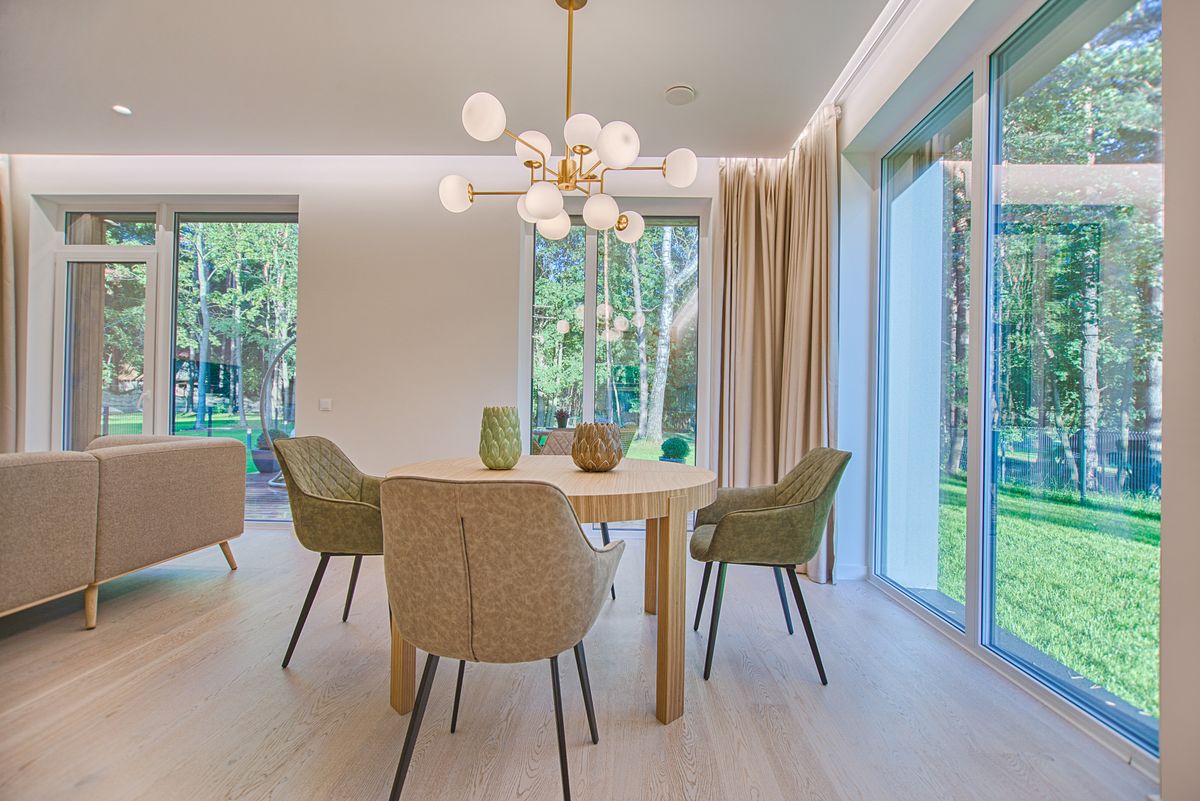 Phòng ăn với cửa kính lớn khung mảnh nhìn ra vườn